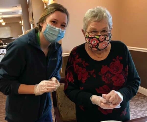 Senior woman and employee make cookies together at a senior living community in Fitchburg, Wisconsin.