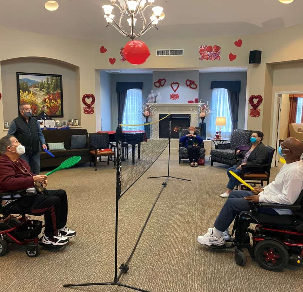 Group of seniors play a game of indoor volleyball at a senior living facility in Richardson, Texas.