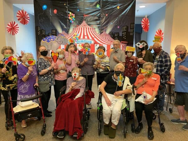 Seniors smile while at a party at a senior living community in Richardson, Texas.