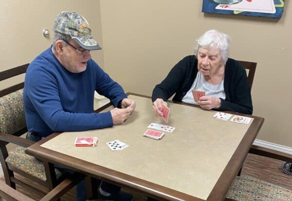 Two seniors playing a game of cards at the Waterford at Mansfield, a senior living community in Mansfield, Ohio.