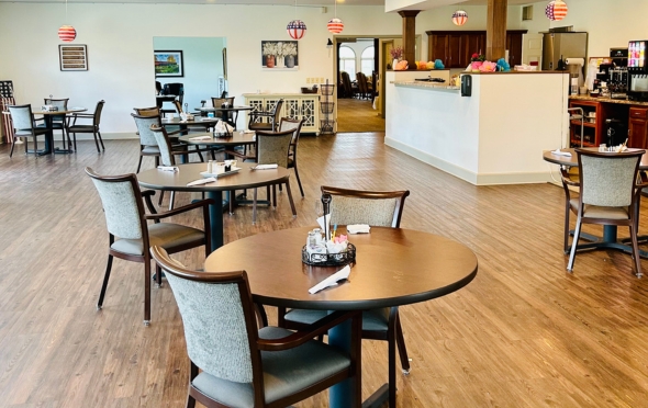 Senior living community dining room with multiple tables and chairs