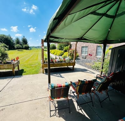 courtyard with chairs and garden beds at a senior living community