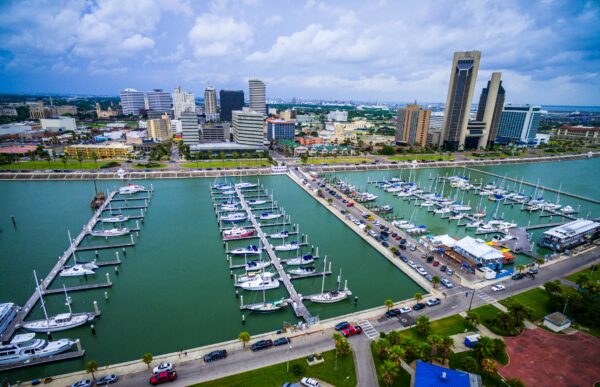 Corpus Christi Texas bayfront Skyline view of City with many rows of piers filled with boats and sailboats and yachts across the summer vacation landmark getaway.