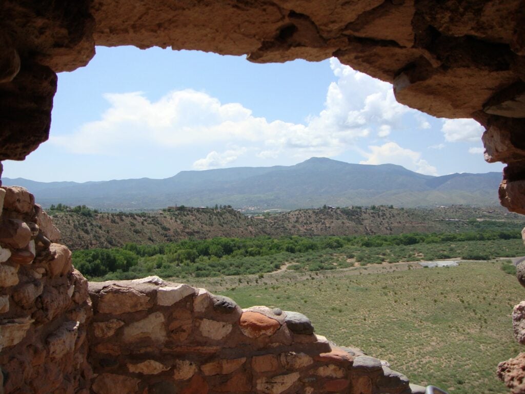 A landscape view through the cut-out window in the wall; ancient Tuzigoot National Monument ruins near Clarkdale, Arizona.