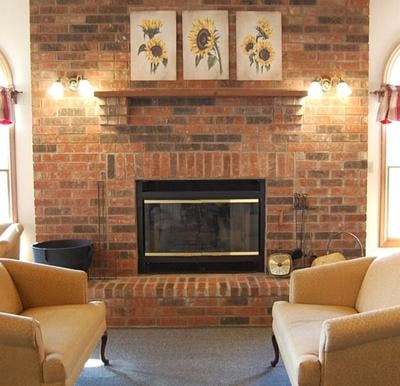 fireplace with two couches nearby at Country Charm assisted living