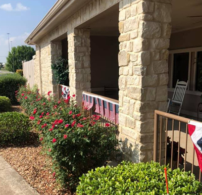 Outdoor view of senior living facility with patriotic decorations in Granbury, Texas.