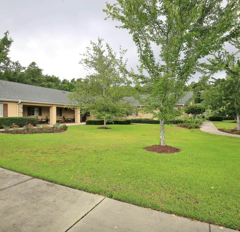 Outdoor courtyard area at a memory care community in Pensacola, Florida with walking paths.