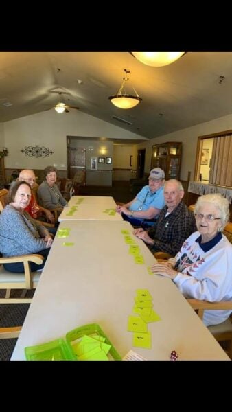 Group of seniors playing a game at a senior living community in Plymouth, Wisconsin.