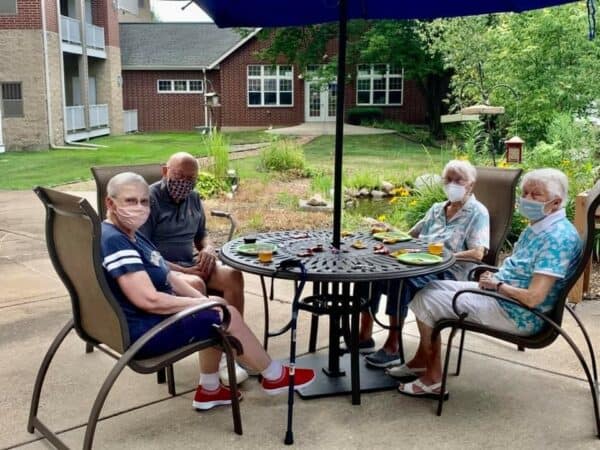 Group of seniors sitting outside at a senior living community in Fitchburg, Wisconsin.
