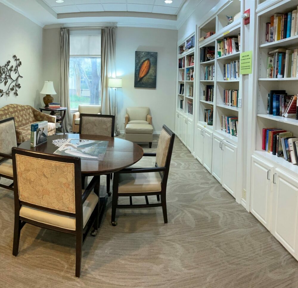 Library with seating area at the Waterford on Highland Colony, a senior living community in Ridgeland, Mississippi.