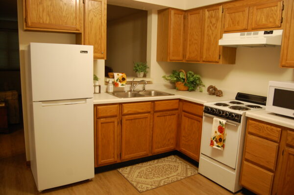 Full-sized kitchen with stove and refrigerator at senior living community in Greenwood, Indiana.