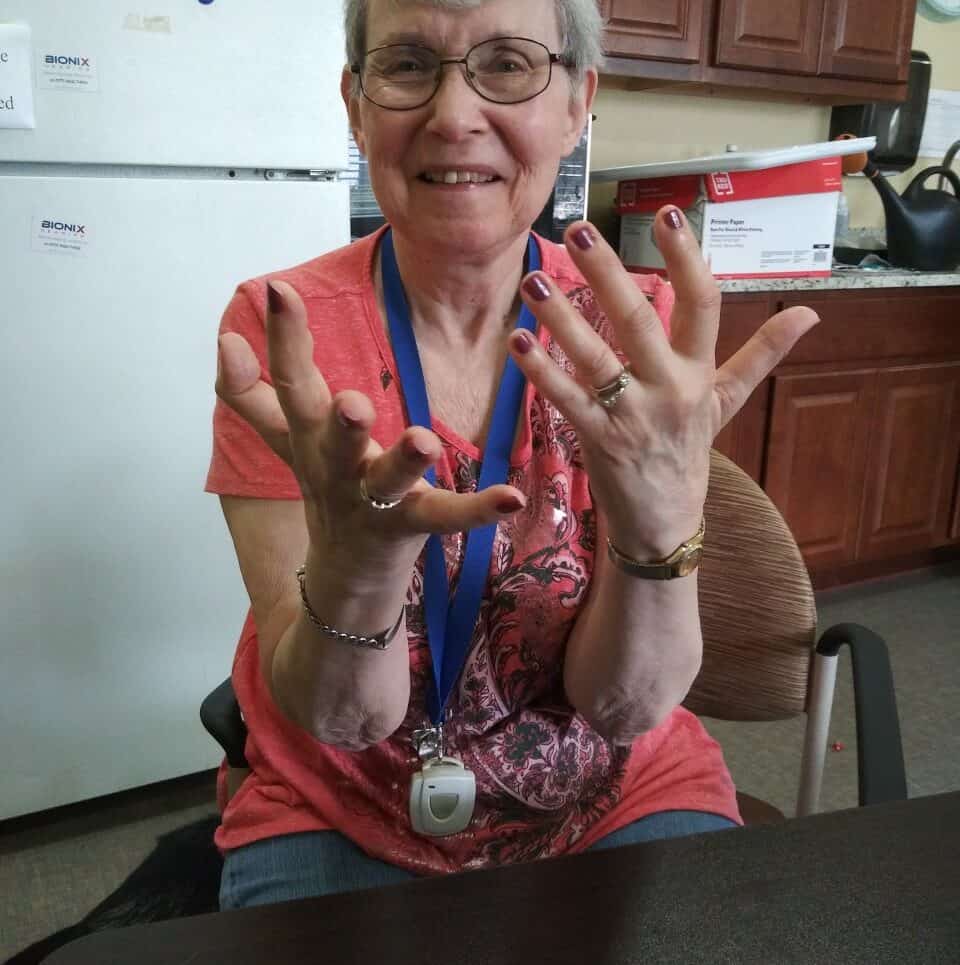 Senior woman showing off her painted nails at Whitley Place in Keller, Texas.