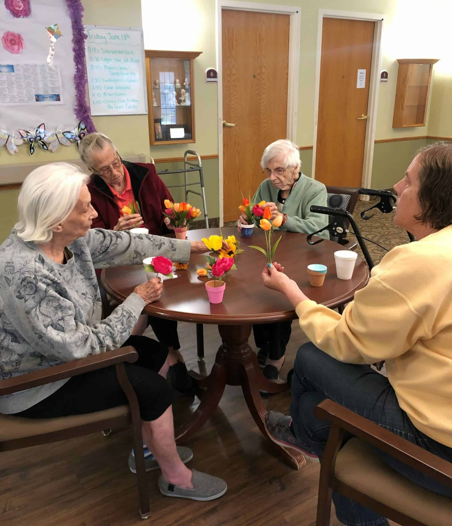Group of senior women put flowers together at a senior living community in Elkhorn, Nebraska.