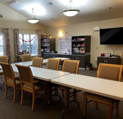 activity room has a long table with many chairs and a TV