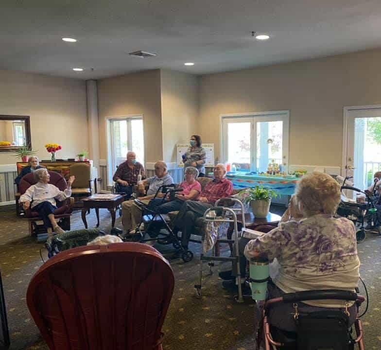 Large group of seniors gathered in an activity room at a senior living facility in Greencastle, Indiana.
