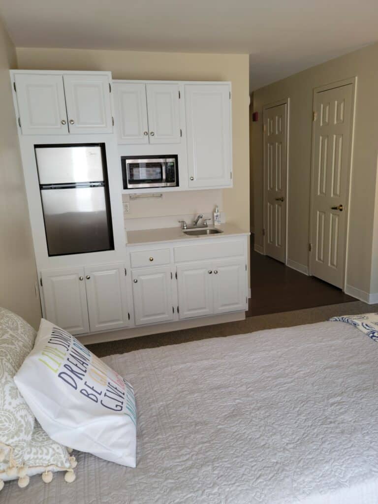White studio kitchenette at senior living facility in Virginia Beach, Virginia.