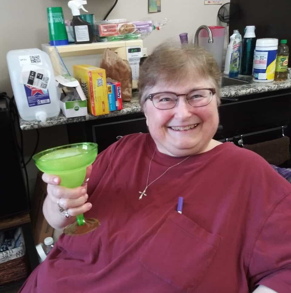An older woman enjoying a margarita at her Keller, Texas senior living community.