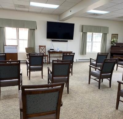 The Amber Room at The Amberleigh is an open room with chairs and a TV