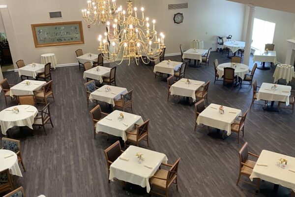 Large dining room with many tables, chairs and chandeliers in Fort Worth, Texas.