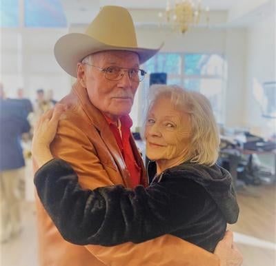 senior man and senior woman dance together at a senior living community