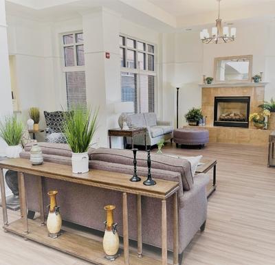 Lobby seating area with a fireplace and chandelier