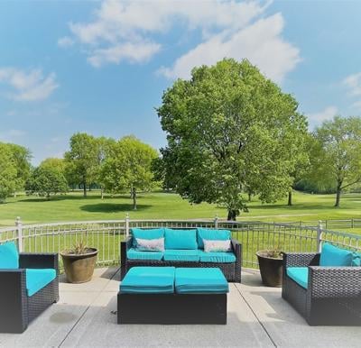 three outdoor couches overlook a golf course
