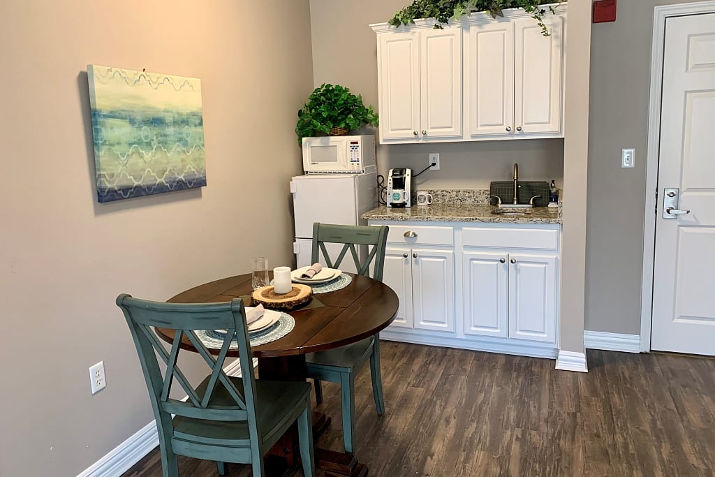 Kitchen and seating area in an apartment at a senior living community in Plano, Texas.