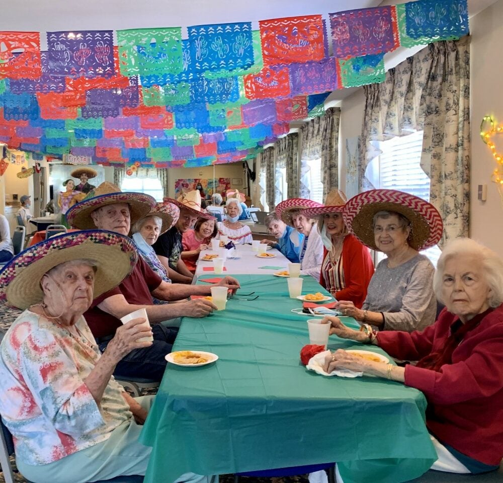 Group of seniors eat together during a Cinco de Mayo party at a senior living community in Irving, Texas.