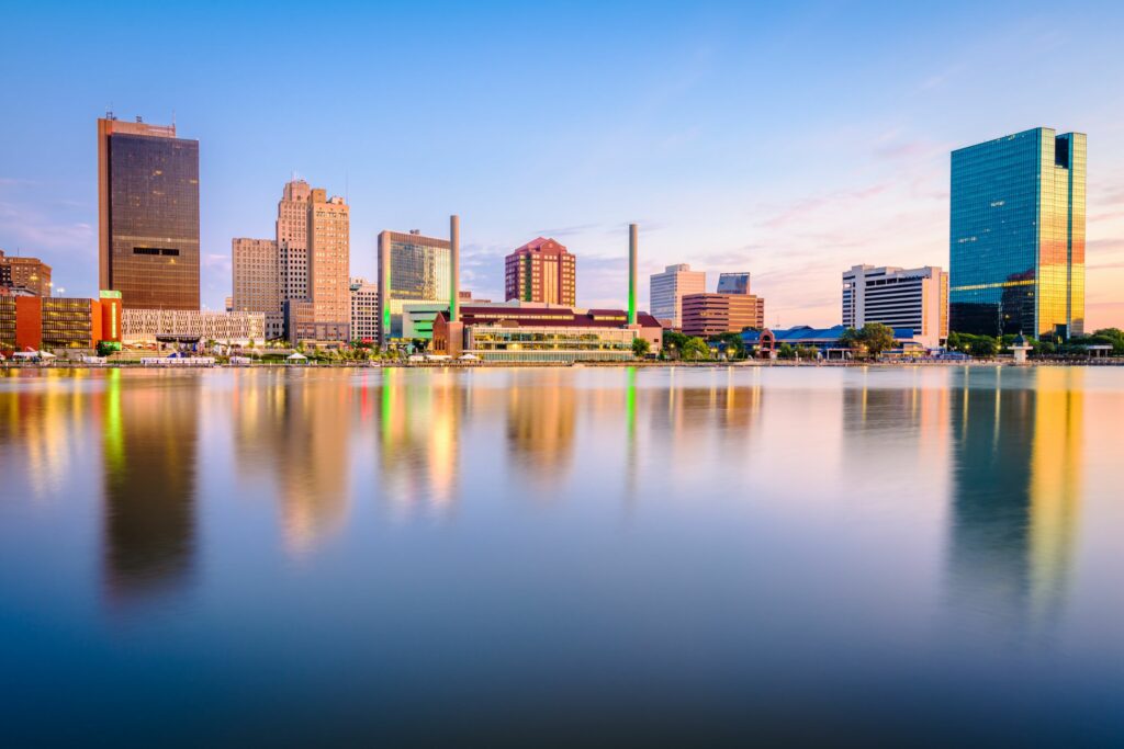 Toledo, Ohio, USA downtown skyline on the Maumee River at dusk