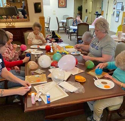 Group of senior women work on various craft projects