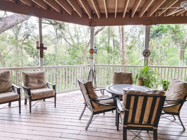 outdoor patio with chairs and a table overlooking carpenters creek