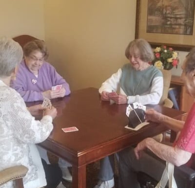 Four senior women play cards at a senior living community in Dayton, Ohio.