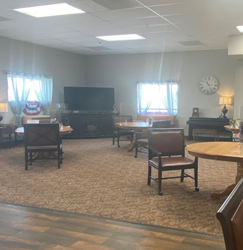 Lounge area with large TV and seating areas at a senior living community in Plattsmouth, Nebraska.