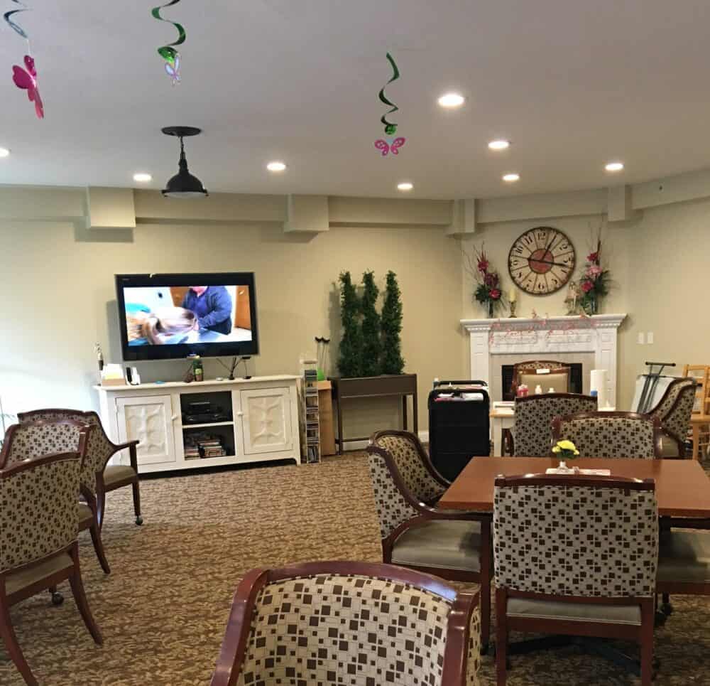 Activity center with seating and a TV at a senior living community in Rochester, Indiana.