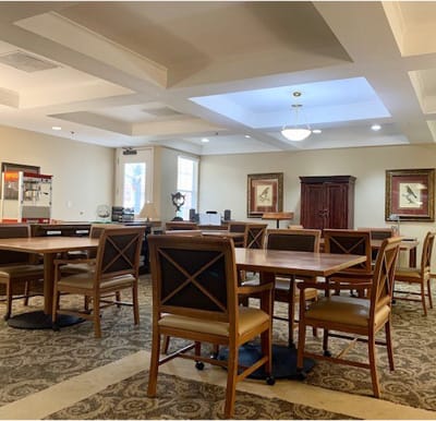 An activity center with many tables, coffered ceilings and bright lighting in Arlington, Texas.