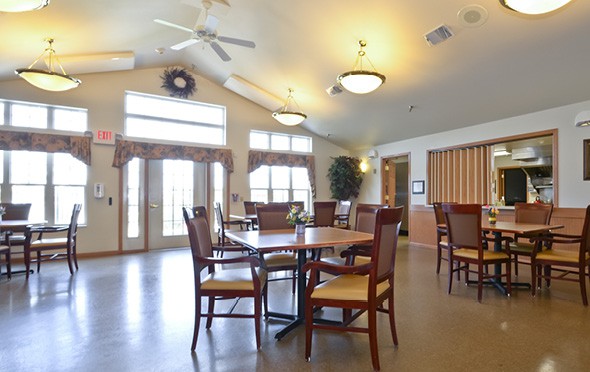 A bright dining room with large windows, wood floors and many tables in Plymouth, Wisconsin