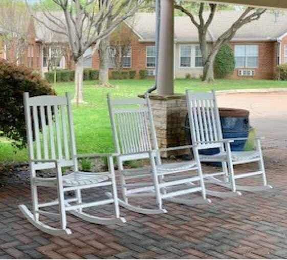 Senior living community rocking chairs in outdoor courtyard in Arlington, Texas.
