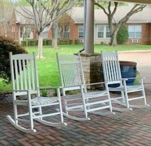 Senior living community rocking chairs in outdoor courtyard in Arlington, Texas.