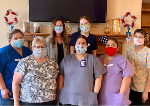 A group of staff wearing protective facial masks and ready to serve their residents in Plymouth, Wisconsin.