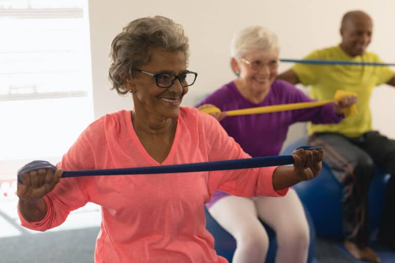 Seniors use stretch bands for resistance exercises.