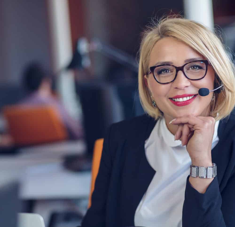 Woman in headset working at the computer.