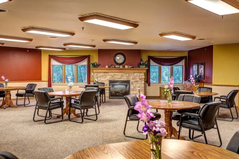 Dining room with tables, chairs and fireplace in Hartford, Wisconsin.