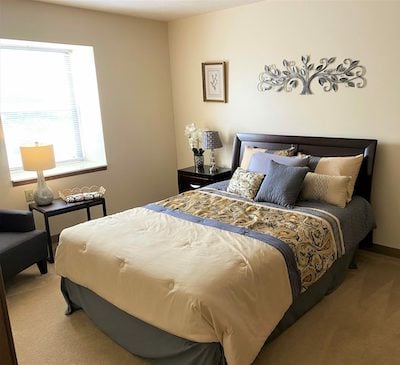 A senior living apartment bedroom with private room