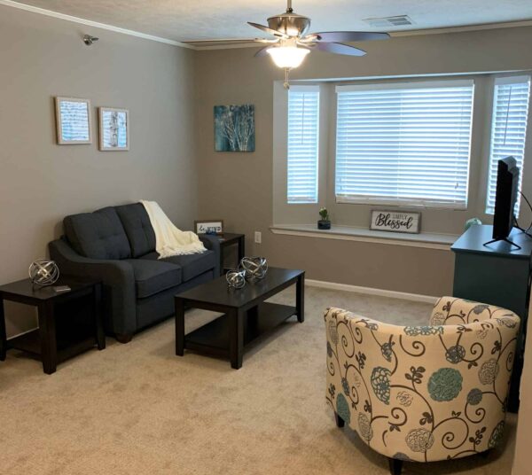 Senior apartment with bay window, couch and TV at a senior living community in Lincoln, Nebraska.