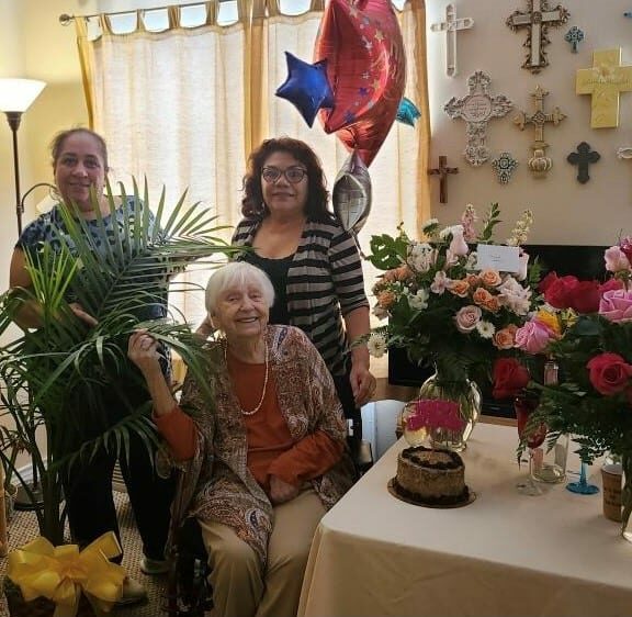 Senior woman celebrating her birthday with her two women friends at senior living facility in Corpus Christi, Texas.