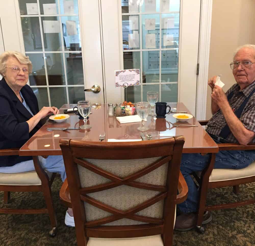 Senior man and senior woman eat together at Wynnfield Crossing, a senior community in Rochester, Indiana