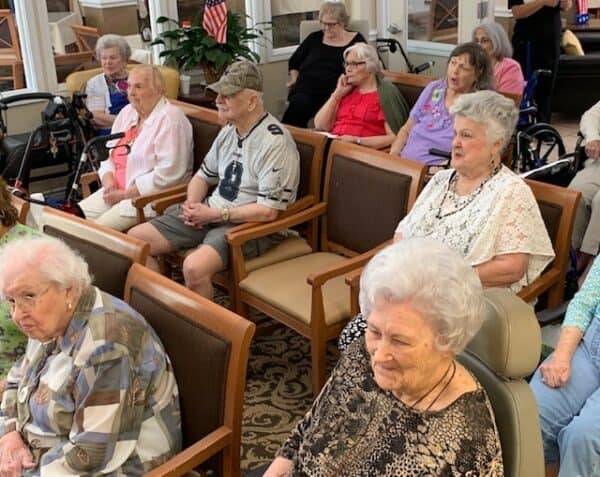 Group of seniors gathering for an event during national assisted living week at senior living facility in Corpus Christi, Texas.