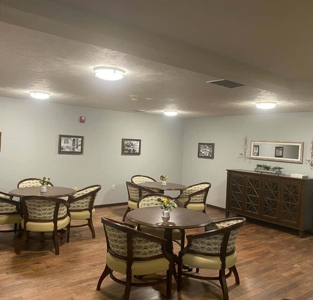 Activity area with tables and chairs at a senior living community in Omaha, Nebraska.
