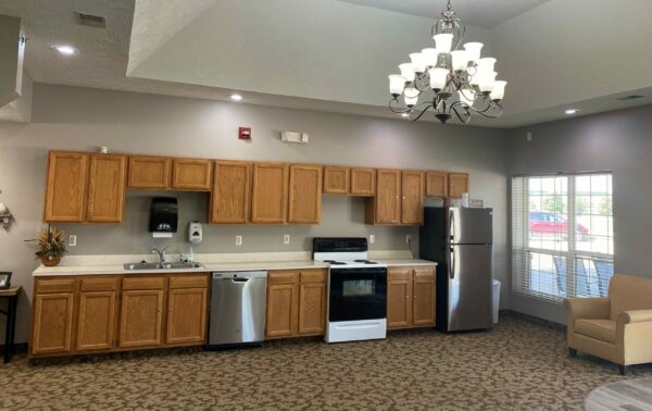 The Waterford at Woodbridge community kitchen area with oven and fridge at a senior living community in Plattsmouth, Nebraska.
