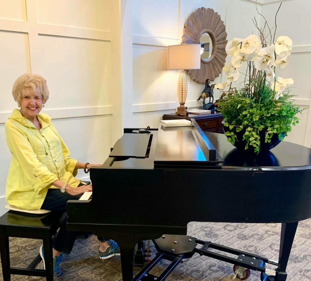 senior woman smiles while playing the piano